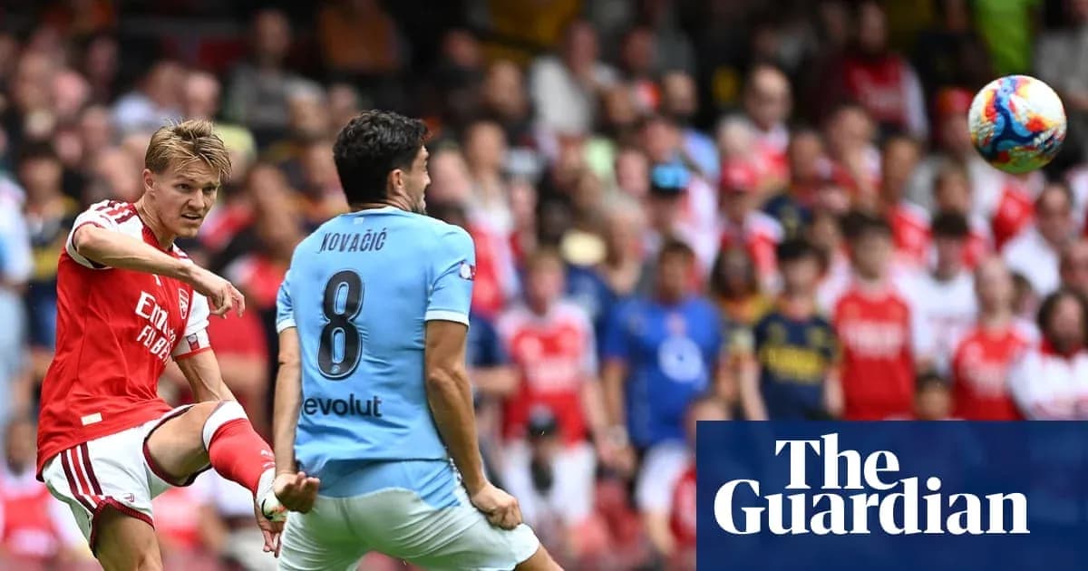 Arsenal player passing ball to teammate during match