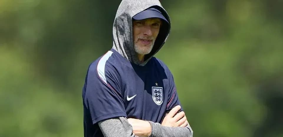 Coach observing training session with hoodie on