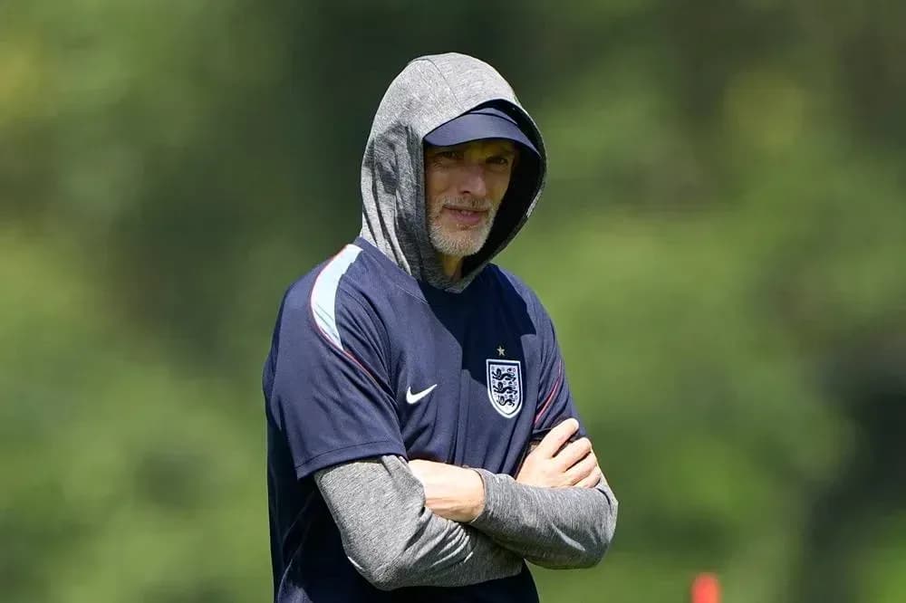 Coach observing training session with hoodie on