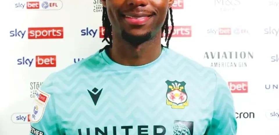 Goalkeeper in club jersey posing for photo
