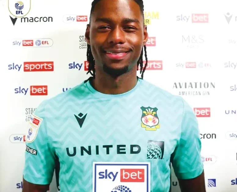 Goalkeeper in club jersey posing for photo