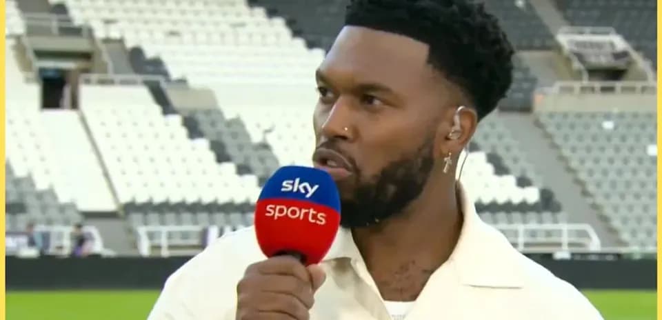 Analyst speaking during post-match interview on pitch