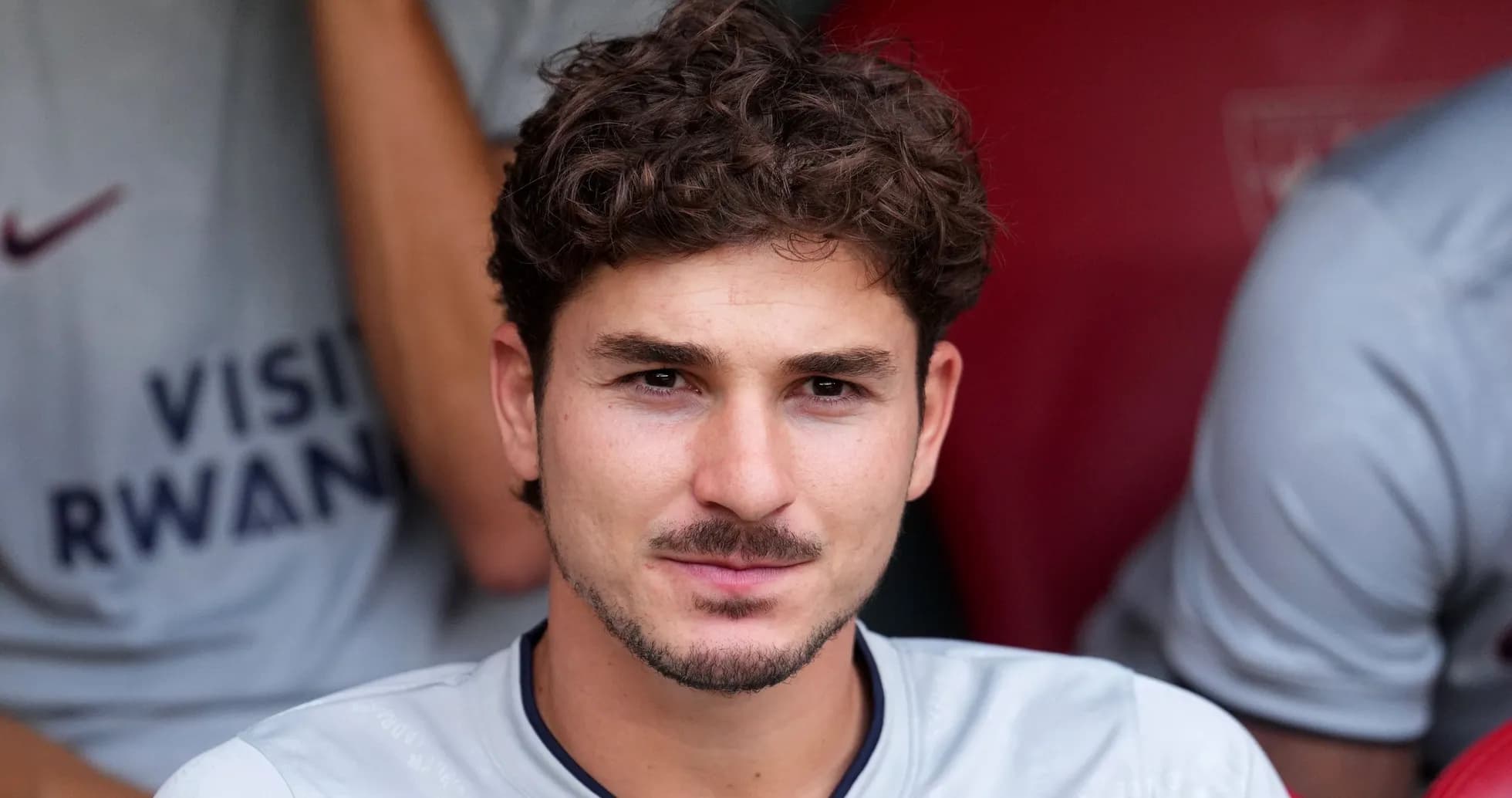 Futbolçu benchdə oturub, kameraya baxır