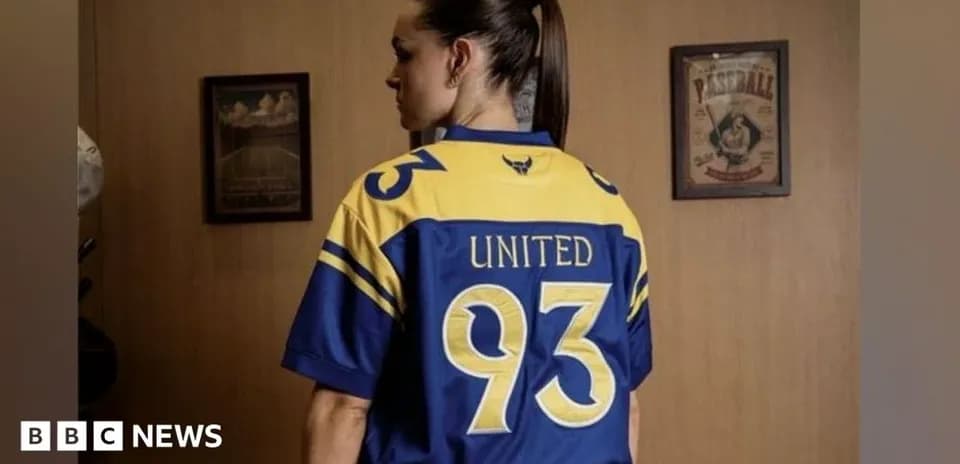 A person wearing a blue and yellow sports jersey