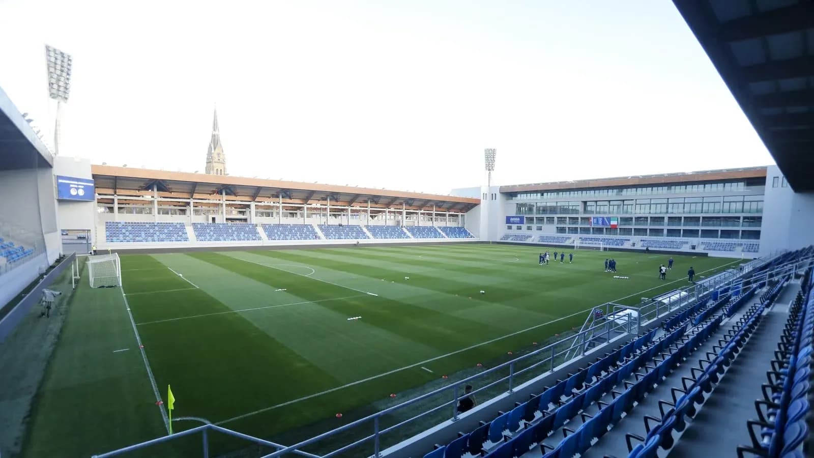 Football stadium with players training on the pitch