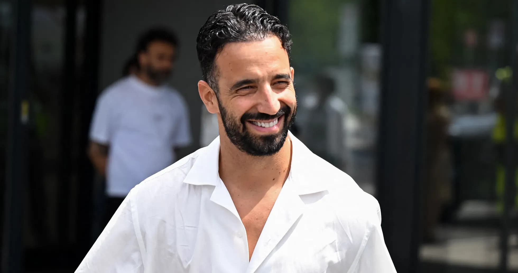 Man smiling while wearing a white shirt