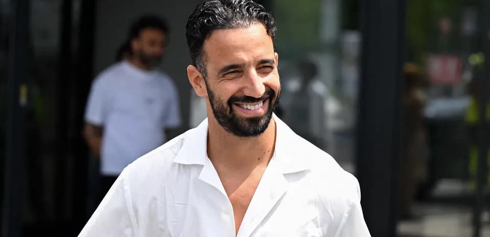 Man smiling while wearing a white shirt