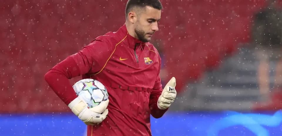Goalkeeper warming up in rain before match
