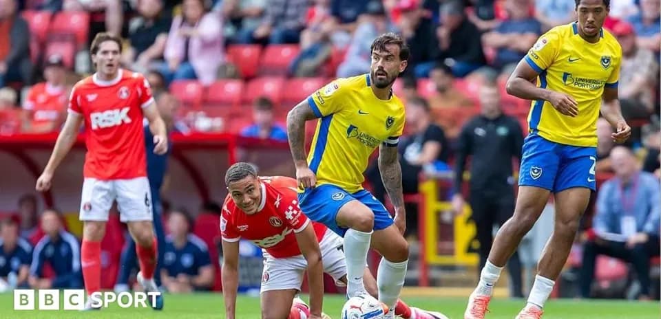 Players competing during a football match at stadium