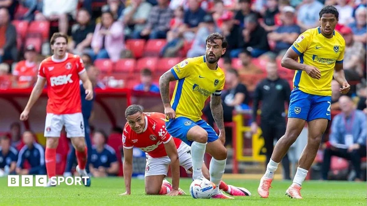 Players competing during a football match at stadium