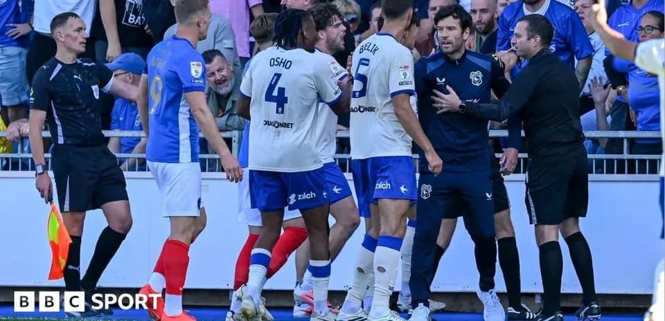 Players arguing with referee during football match