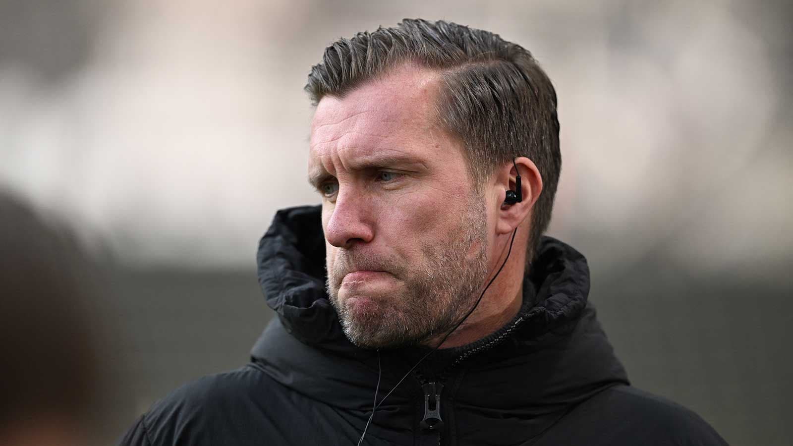 Coach wearing headphones during training session