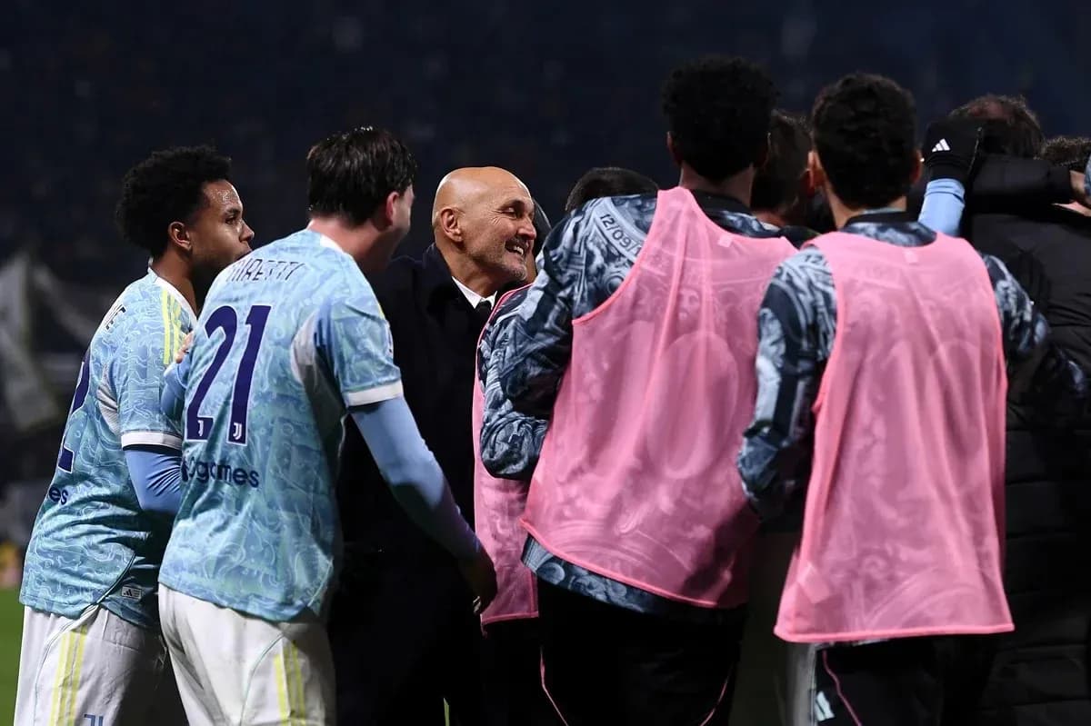 Coaching staff celebrating with players after match