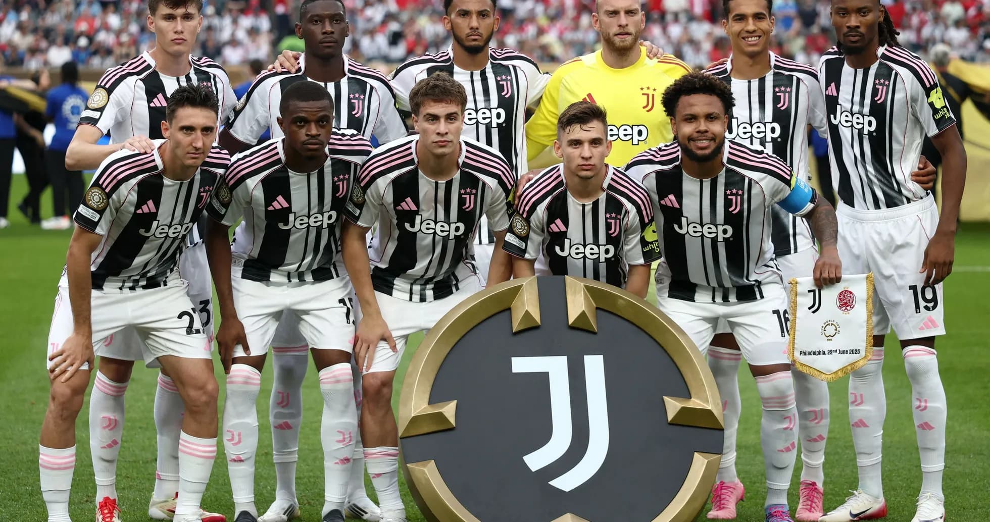 Juventus team posing with club emblem before match