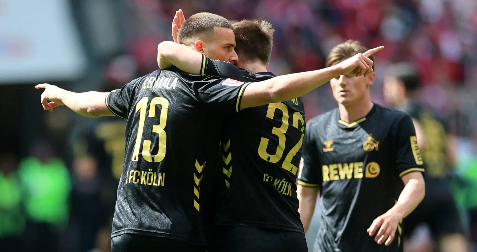 FC Köln players celebrating a goal on the pitch