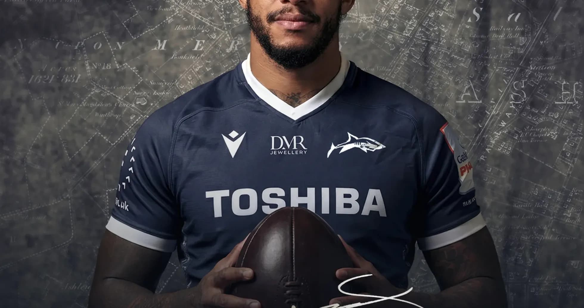 Courtney Lawes holding a rugby ball in jersey