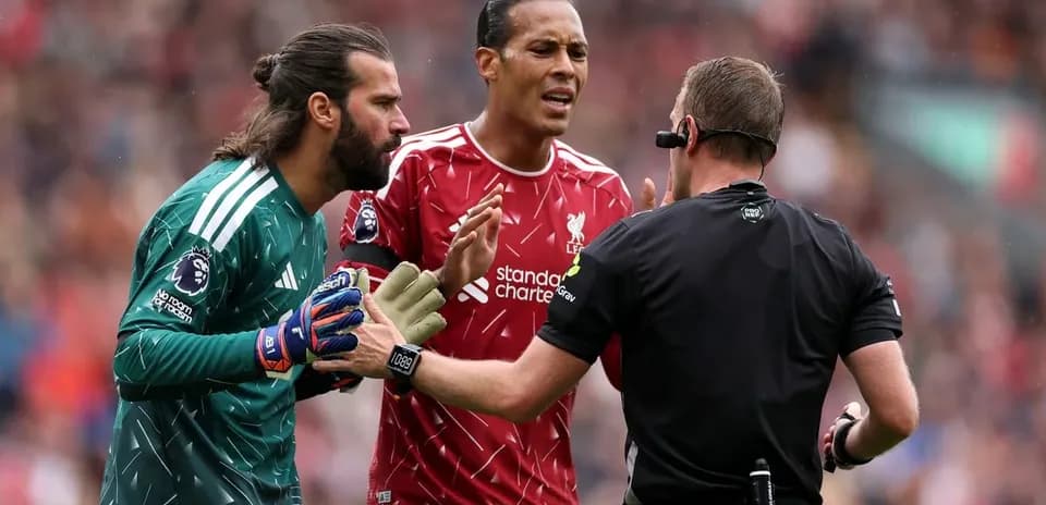Liverpool players discussing with the referee during match