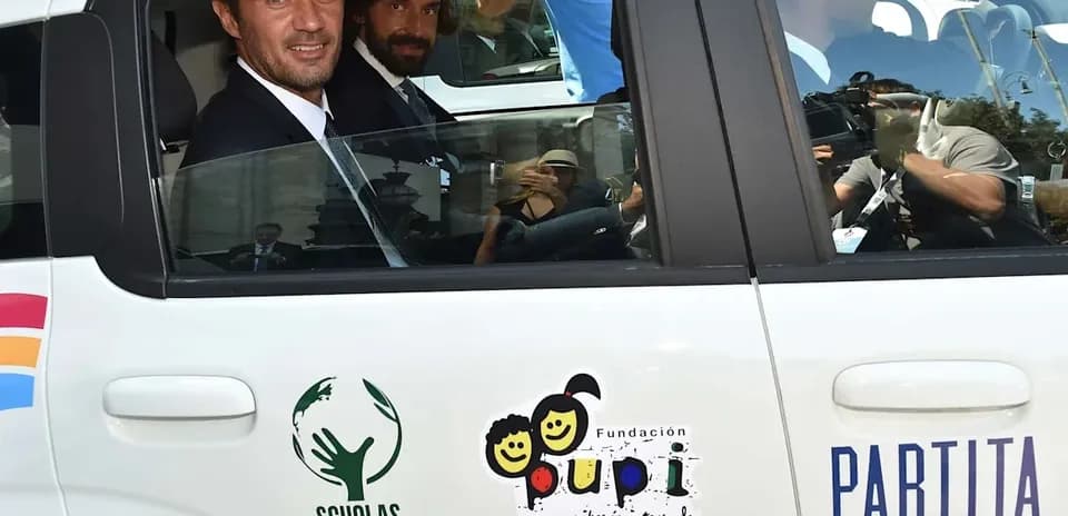 Two men in suits sitting inside a car