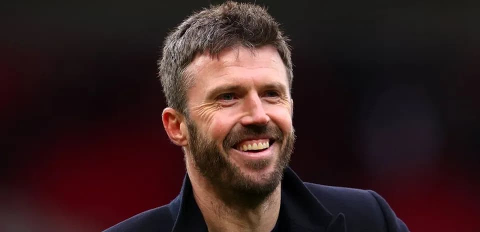 Person smiling in a dark coat at venue