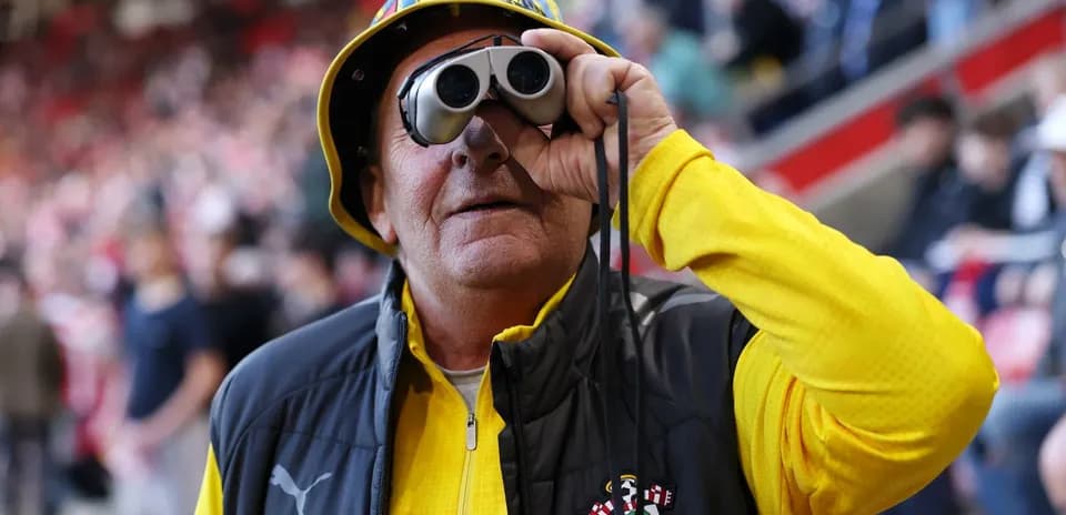 Fan with binoculars wearing Southampton FC attire