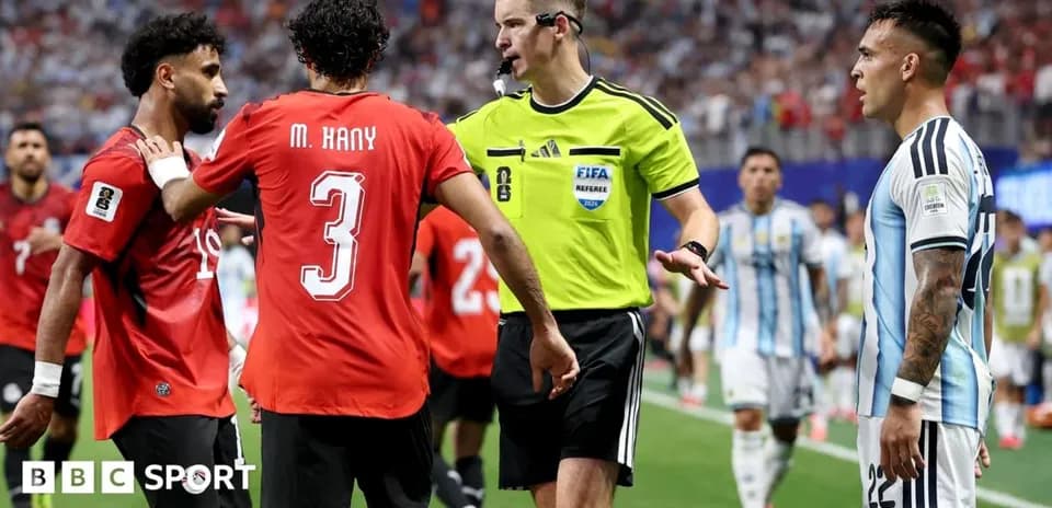 Referee discussing with players during a match
