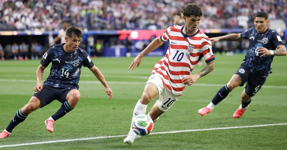 Christian Pulisic dribbling past defenders during match