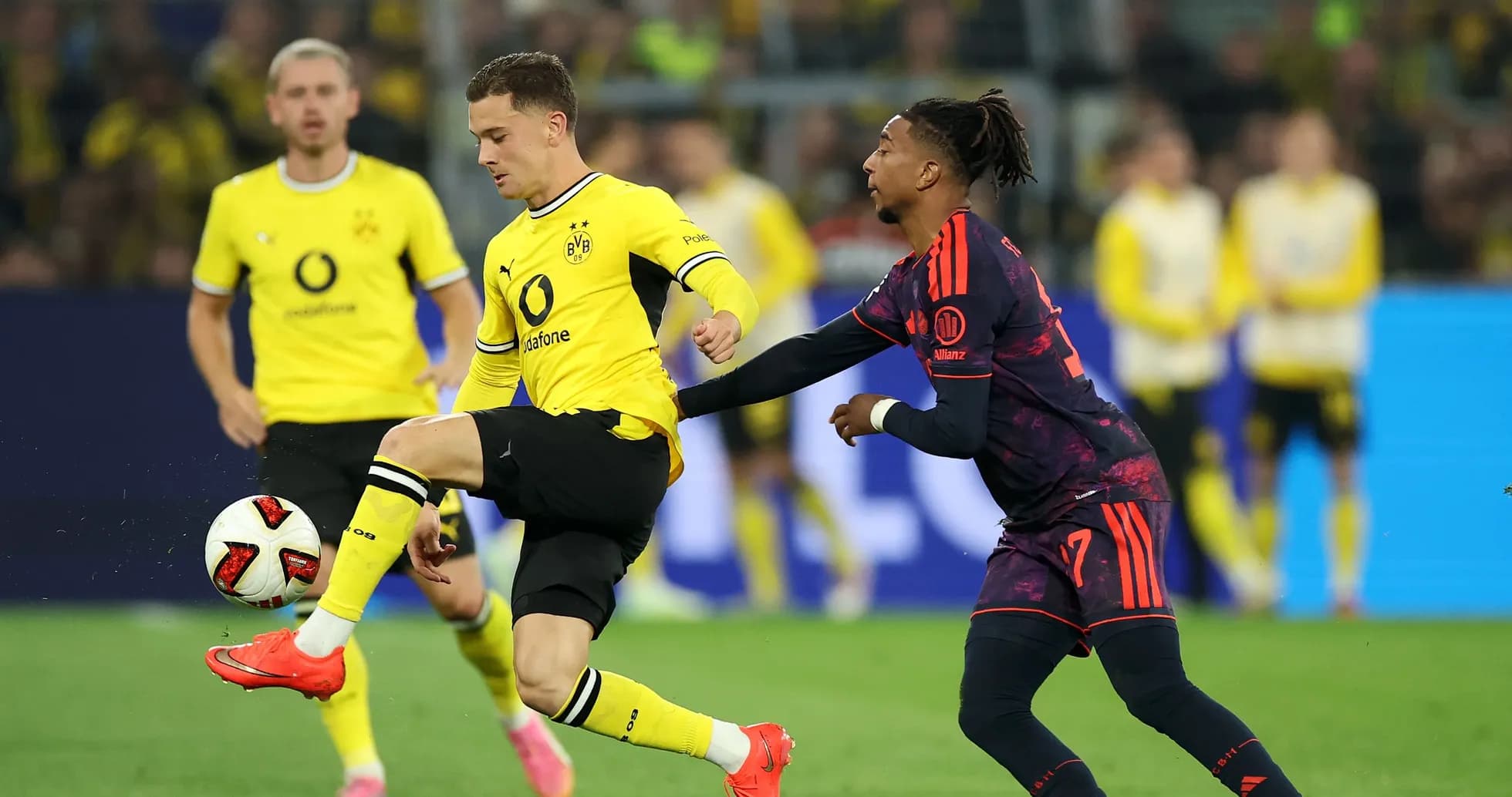 Borussia Dortmund player dribbling past opponent