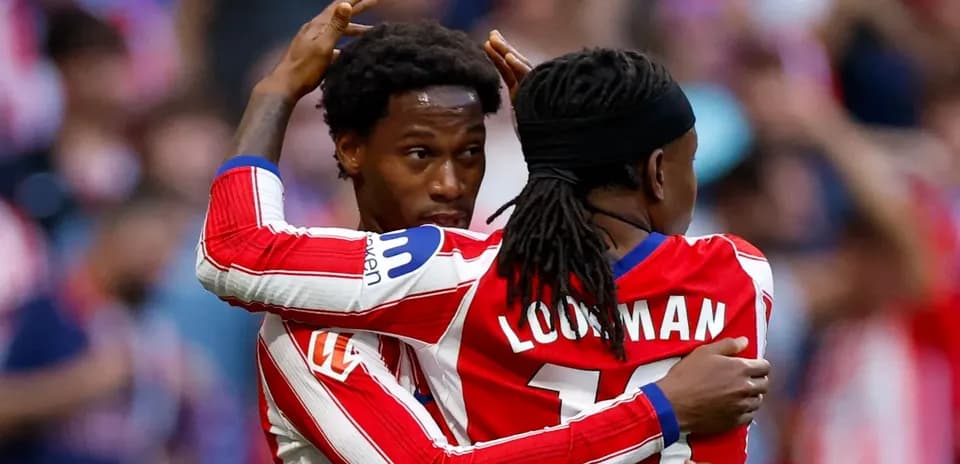Two players celebrating a goal in stadium