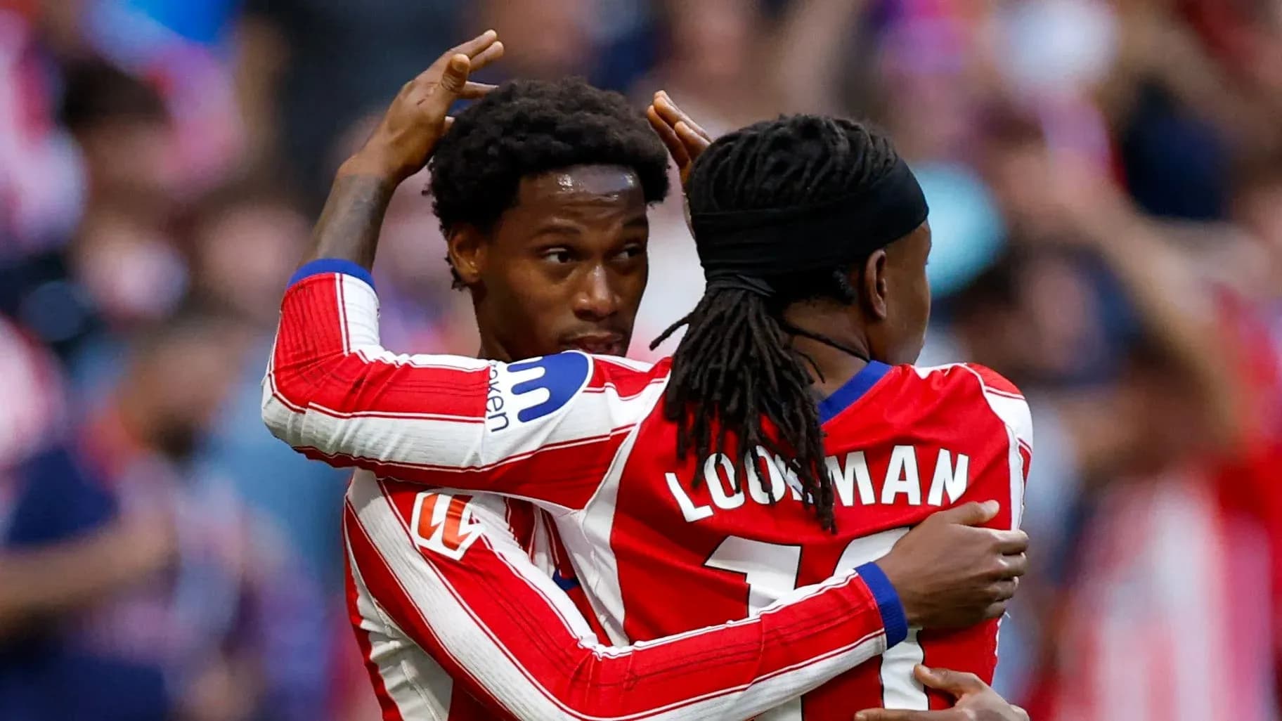 Two players celebrating a goal in stadium