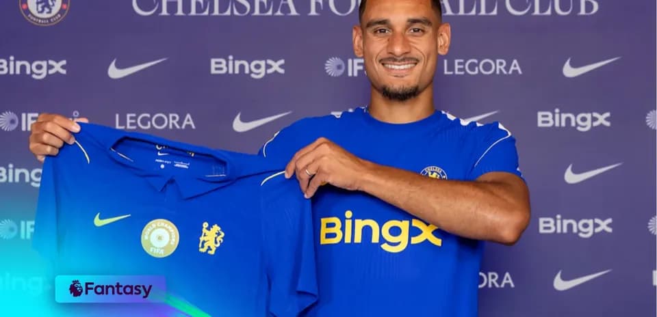 New player holding Chelsea jersey during presentation