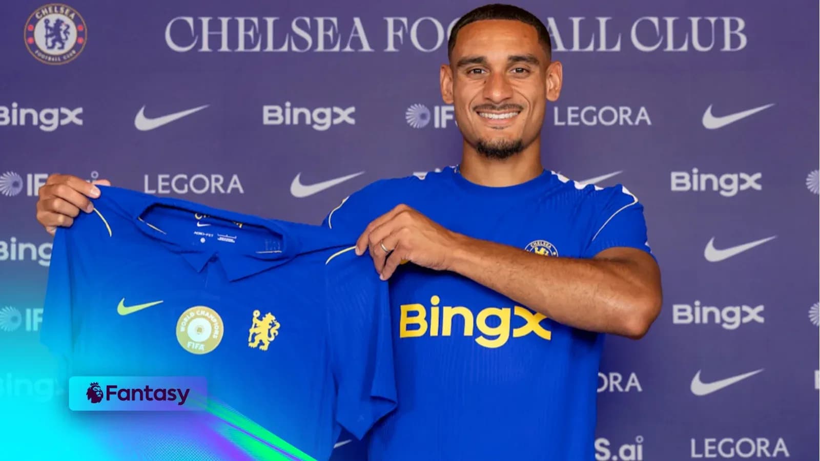 New player holding Chelsea jersey during presentation