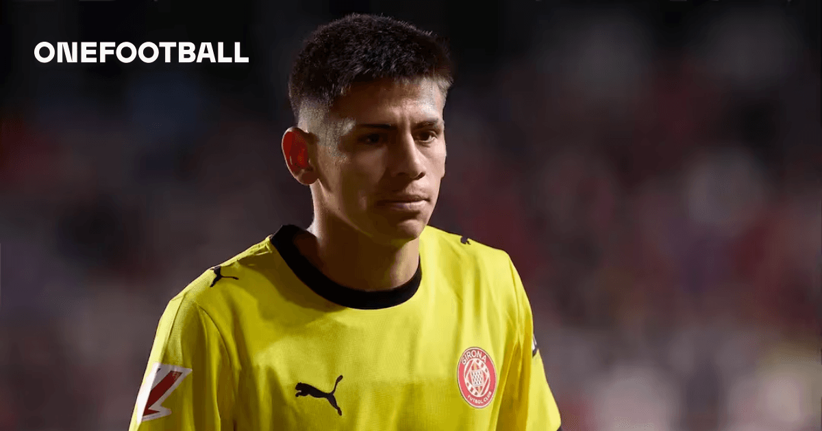 Goalkeeper in yellow kit walking on the field