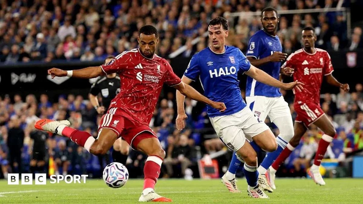 Liverpool player kicking the ball during match