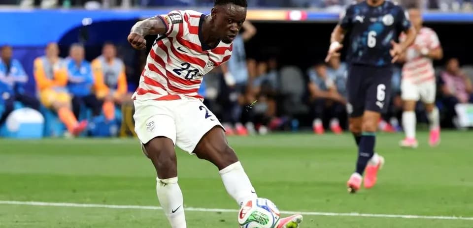 Player kicking ball during match between USA and opponent
