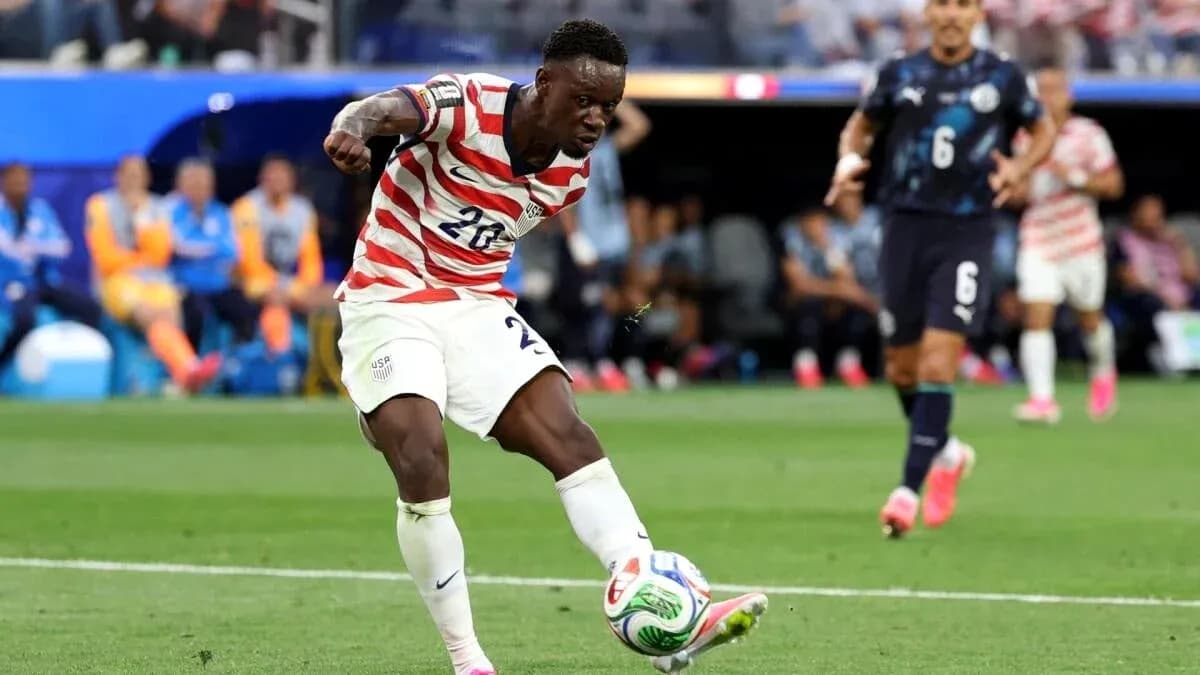 Player kicking ball during match between USA and opponent