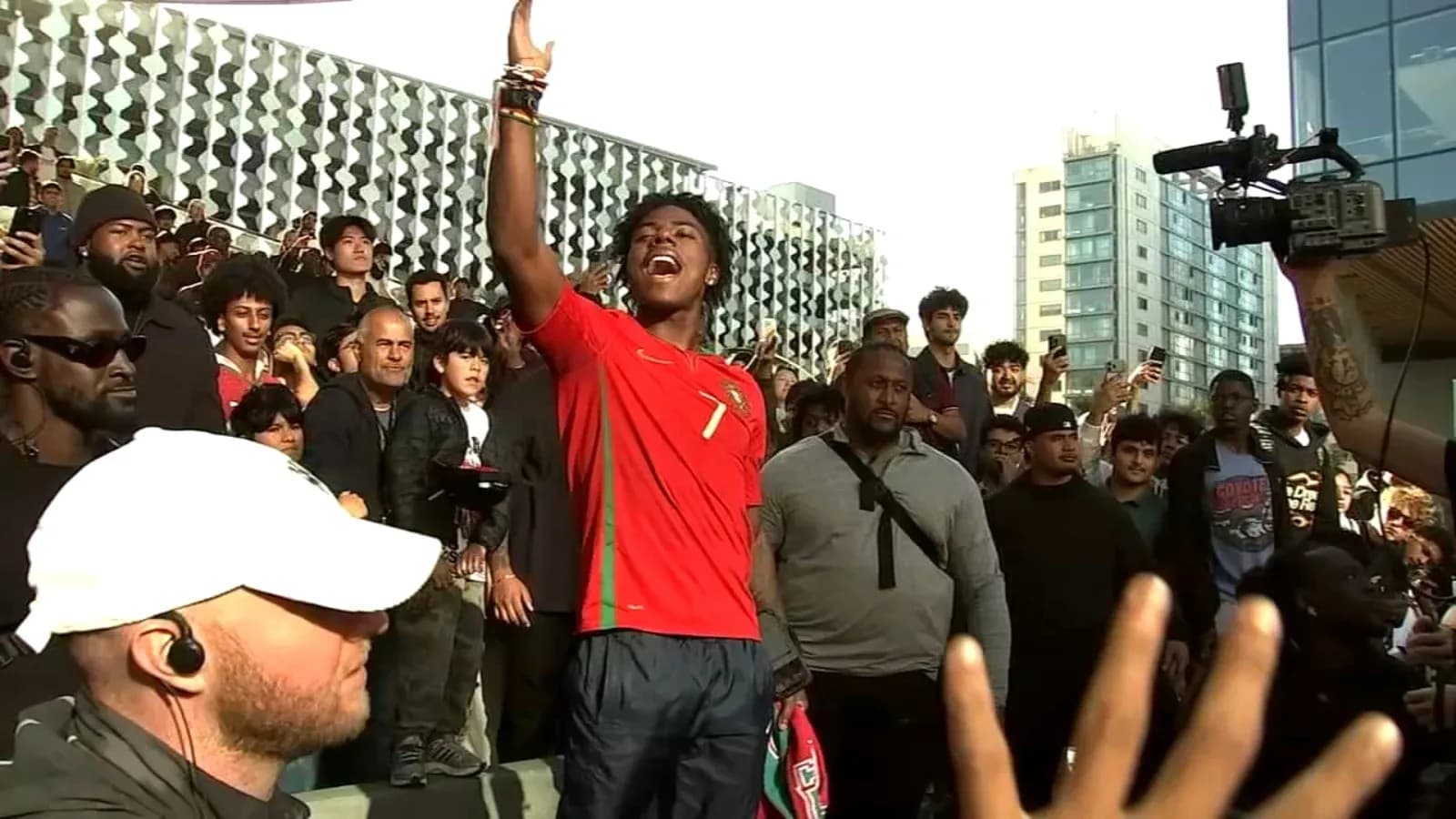Fan celebrating in Portugal jersey with crowd behind
