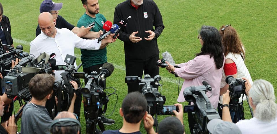 Football manager addressing media during press conference