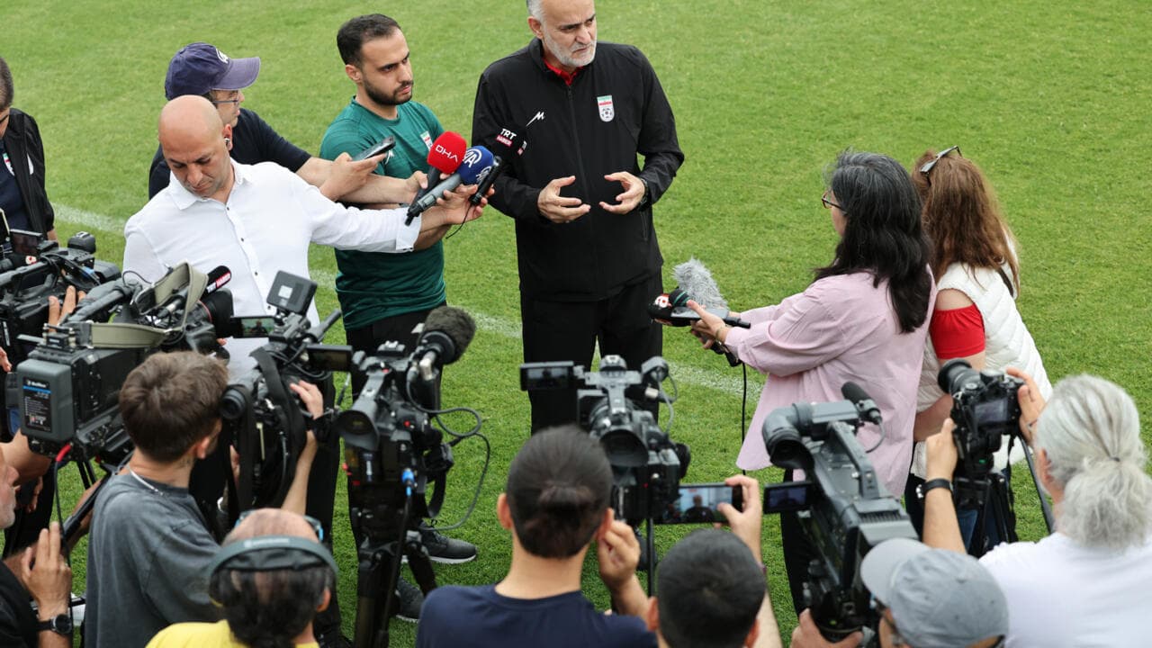 Football manager addressing media during press conference
