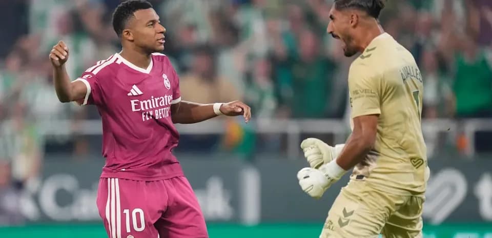 Real Madrid player celebrating with goalkeeper during match