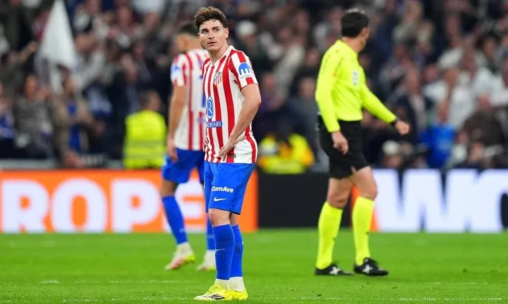 Atletico Madrid player reacting during match with referee