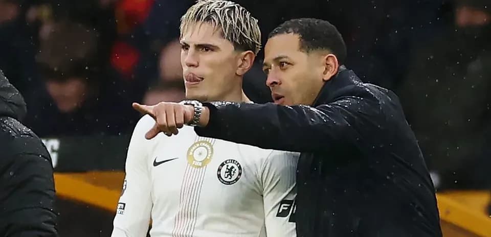 Player receiving instructions from coach on sidelines