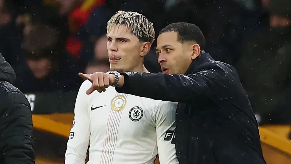 Player receiving instructions from coach on sidelines