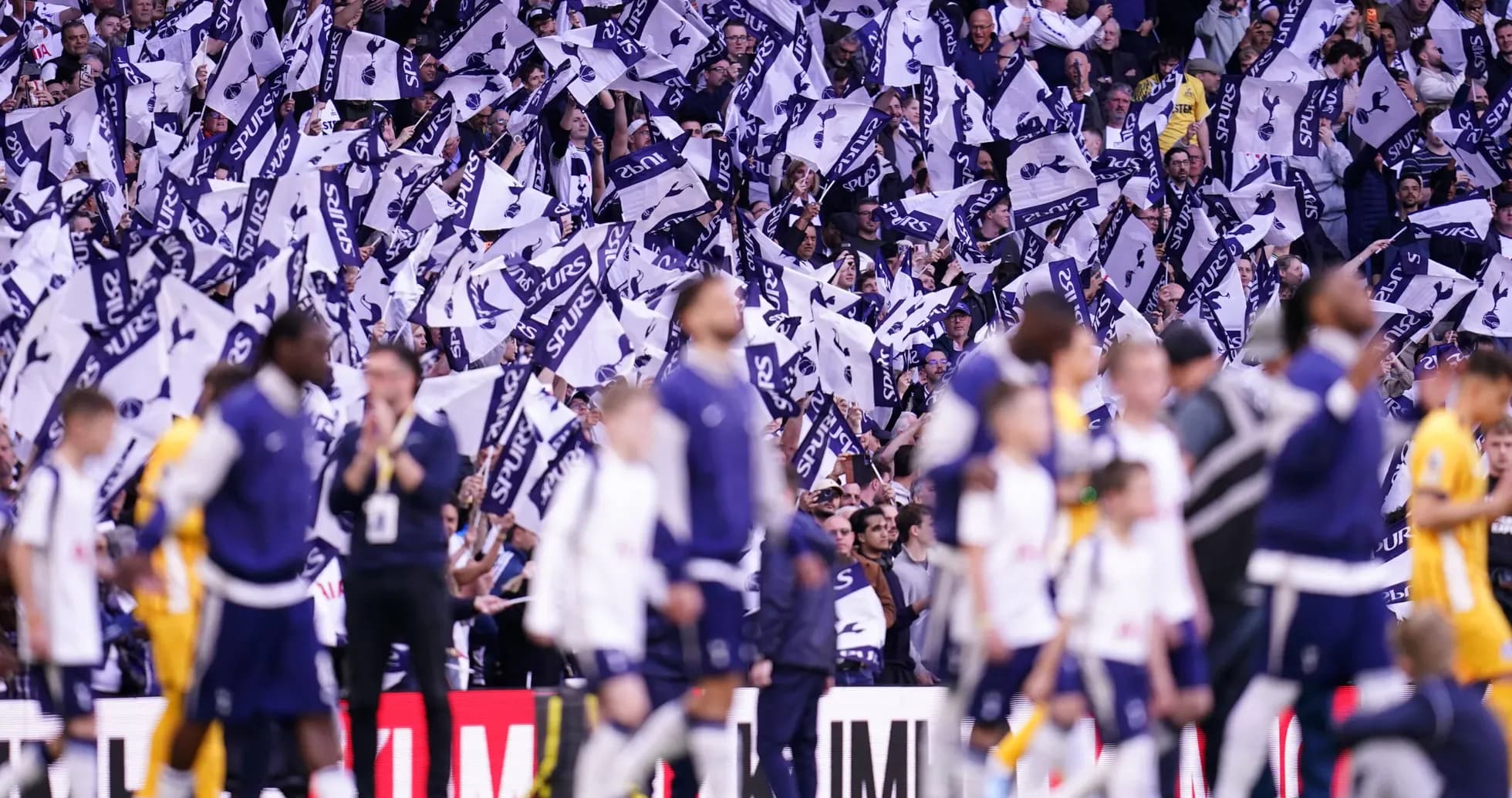 Fans waving flags during Tottenham match celebration