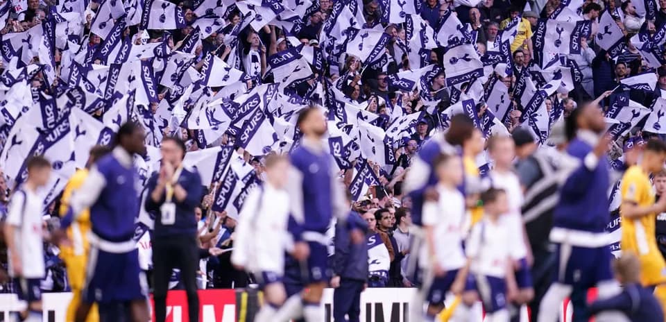 Fans waving flags during Tottenham match celebration