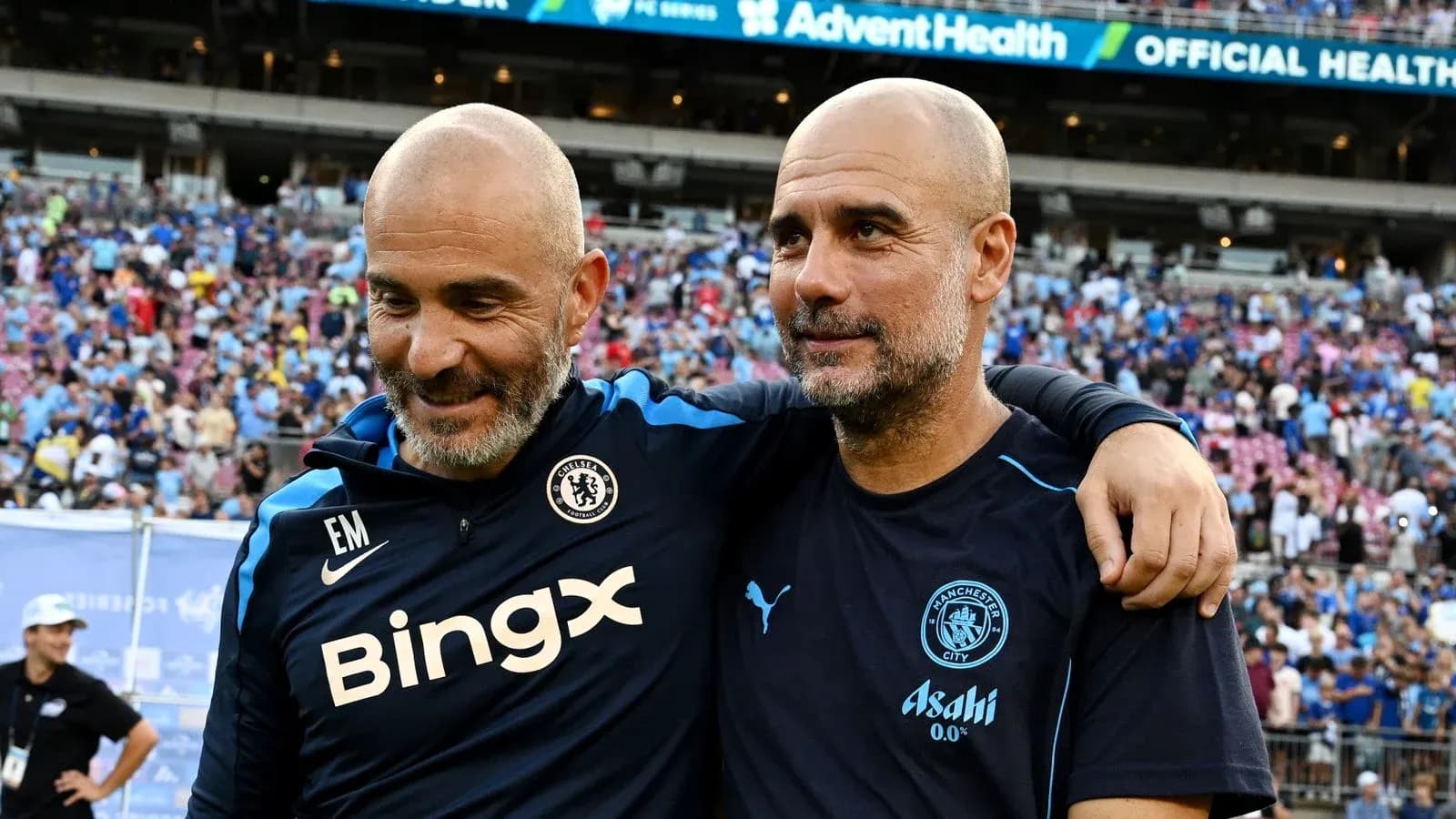 Coaches embracing after a match in stadium