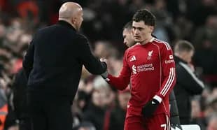 Liverpool player shaking hands with coach after match