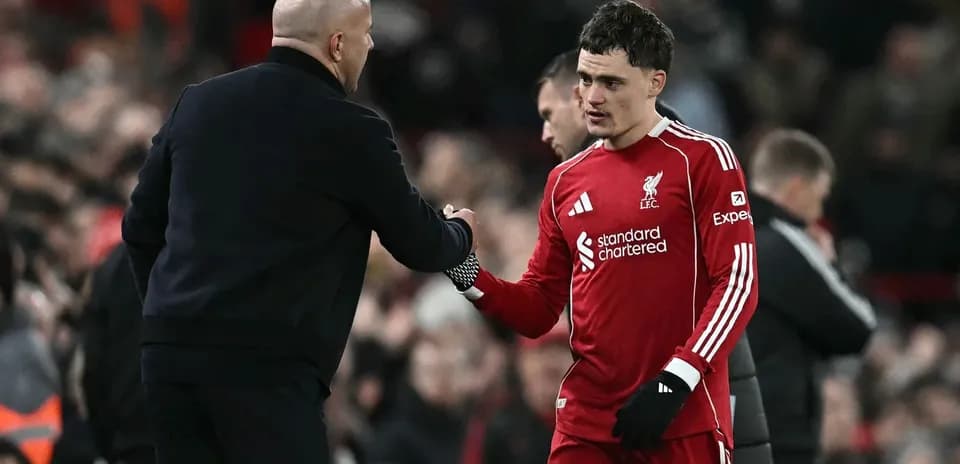 Liverpool player shaking hands with coach after match