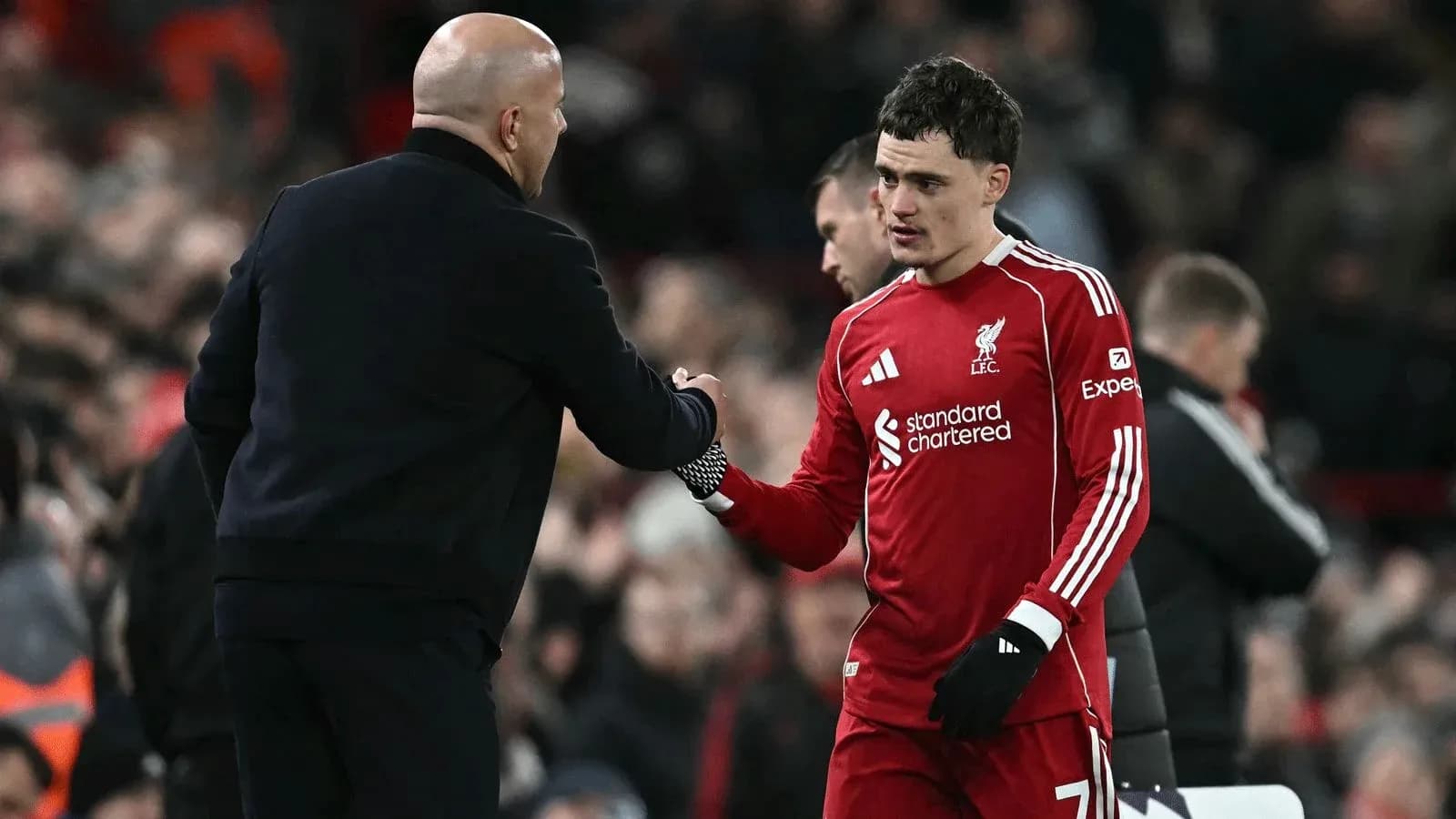 Liverpool player shaking hands with coach after match