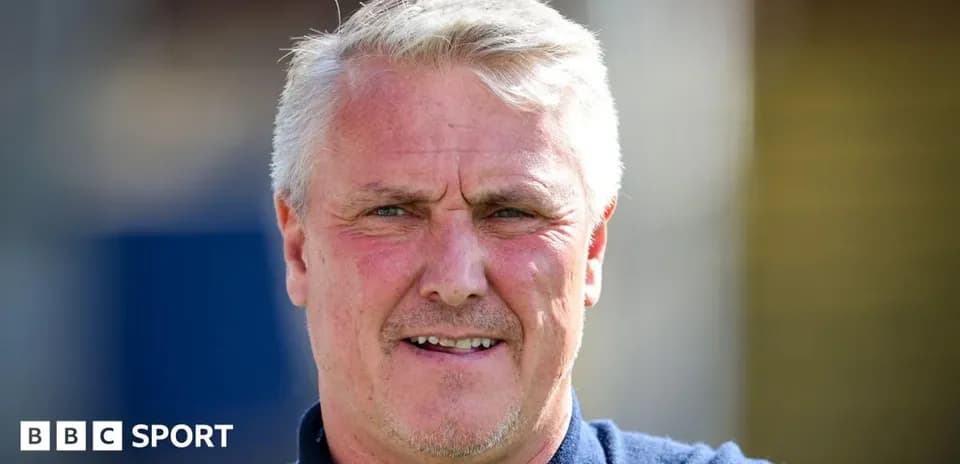 Men's football coach smiling outdoors