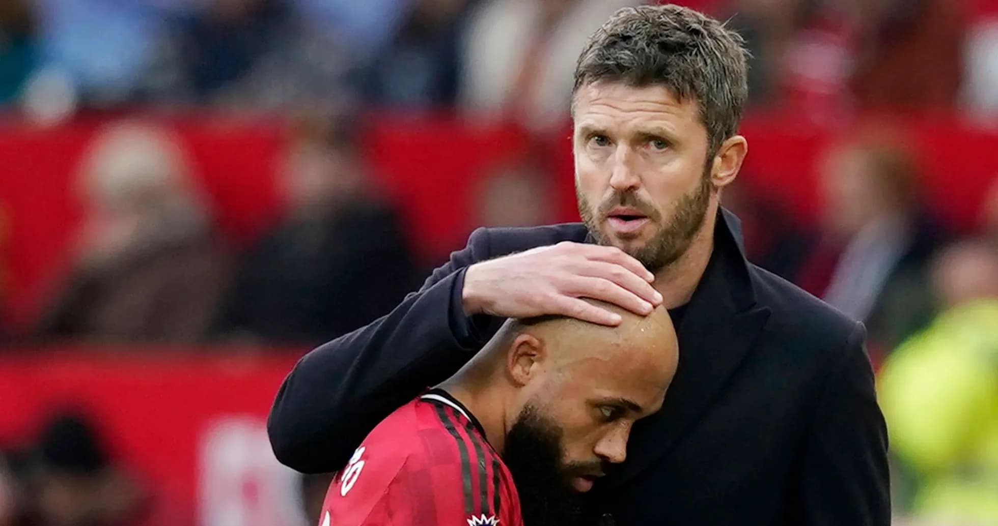 Coach comforting player on the sidelines during match